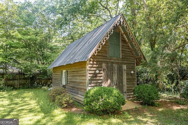 view of outbuilding with a yard