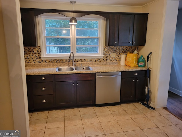 kitchen featuring backsplash, stainless steel dishwasher, dark brown cabinetry, and sink