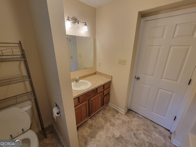 bathroom featuring vanity and toilet