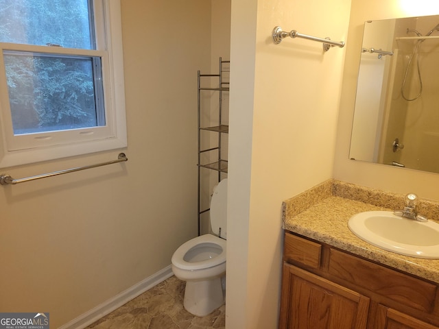 bathroom featuring vanity, toilet, and walk in shower