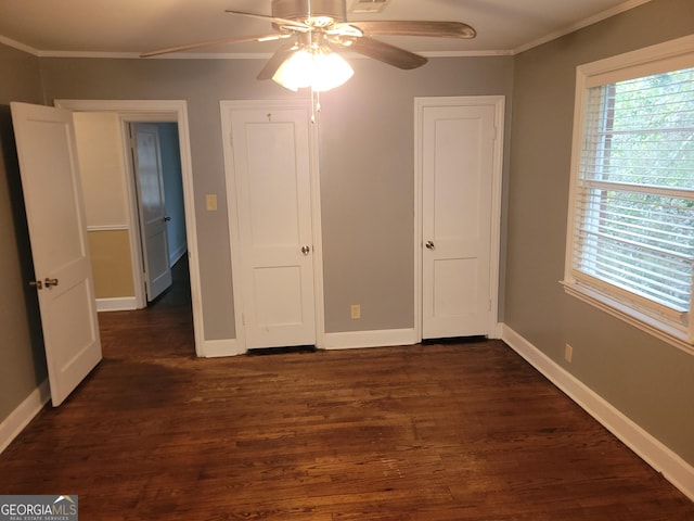 unfurnished bedroom featuring dark hardwood / wood-style floors, ceiling fan, and ornamental molding