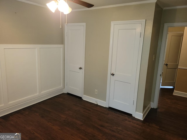 unfurnished bedroom with ceiling fan, dark hardwood / wood-style flooring, and ornamental molding