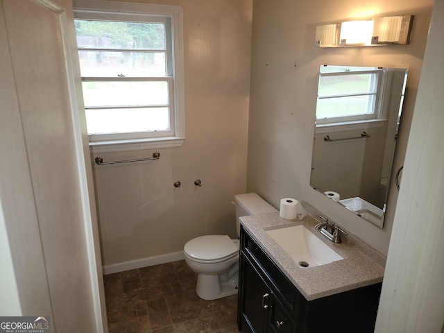 bathroom with vanity, a healthy amount of sunlight, and toilet