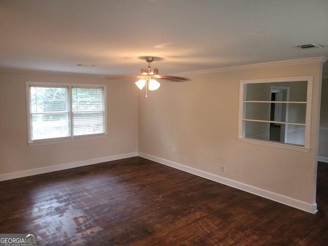 empty room featuring dark hardwood / wood-style floors, ceiling fan, and ornamental molding