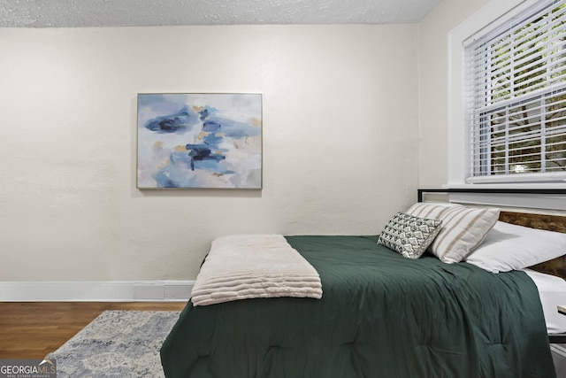 bedroom with wood-type flooring