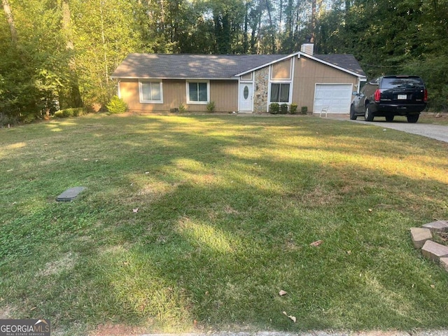 ranch-style house featuring a garage and a front lawn