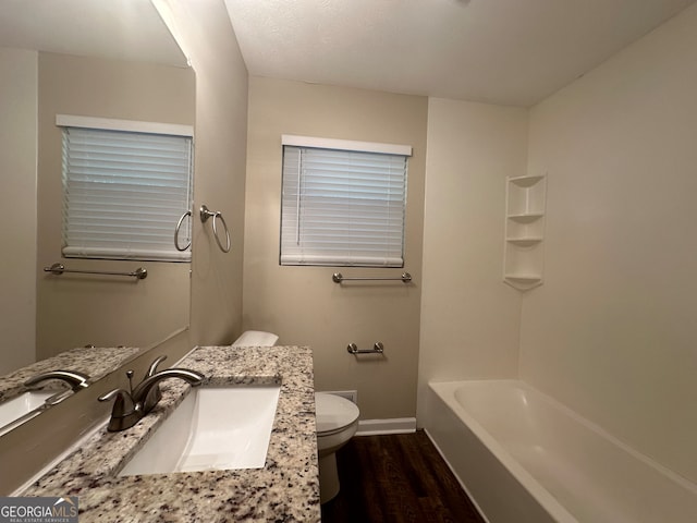 bathroom featuring hardwood / wood-style flooring, vanity, and toilet