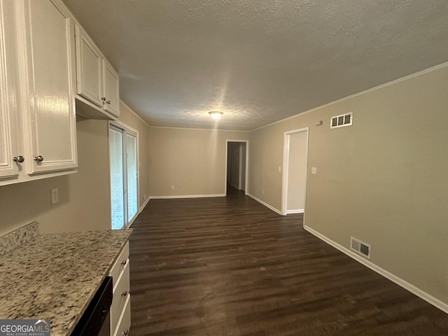3850 Bright Star Rd, Douglasville, GA 30135 - unfurnished dining area with dark wood finished floors, baseboards, a textured ceiling, and crown molding
