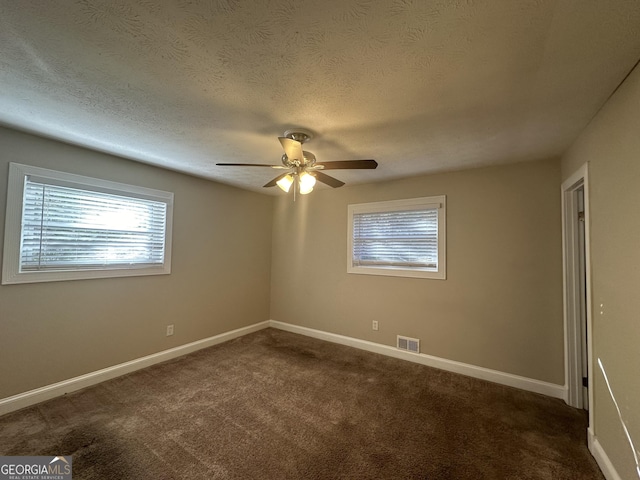 3850 Bright Star Rd, Douglasville, GA 30135 - spare room with ceiling fan, dark colored carpet, baseboards, and a textured ceiling