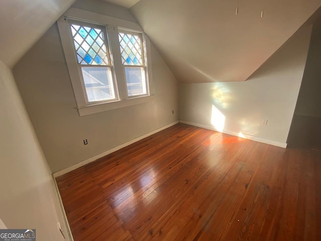 bonus room featuring vaulted ceiling and hardwood / wood-style flooring