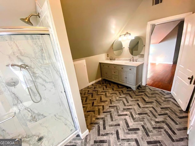 bathroom featuring hardwood / wood-style flooring, a shower with door, vanity, and lofted ceiling