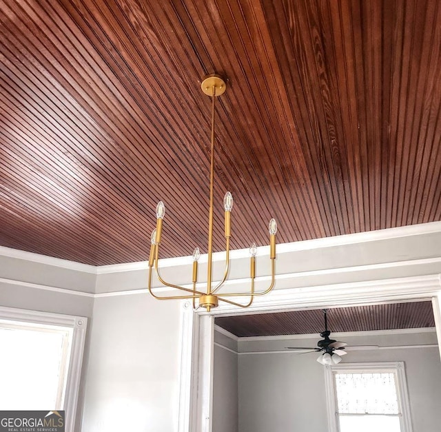 room details featuring ornamental molding, ceiling fan with notable chandelier, and wooden ceiling