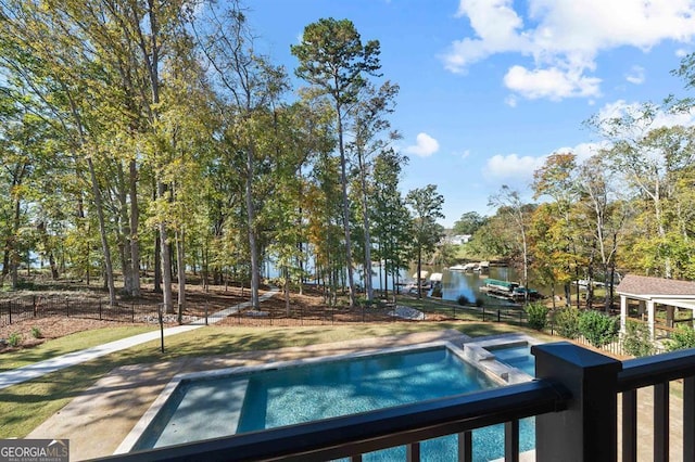 view of pool featuring an in ground hot tub and a water view