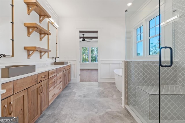 bathroom featuring separate shower and tub, vanity, ceiling fan, and crown molding