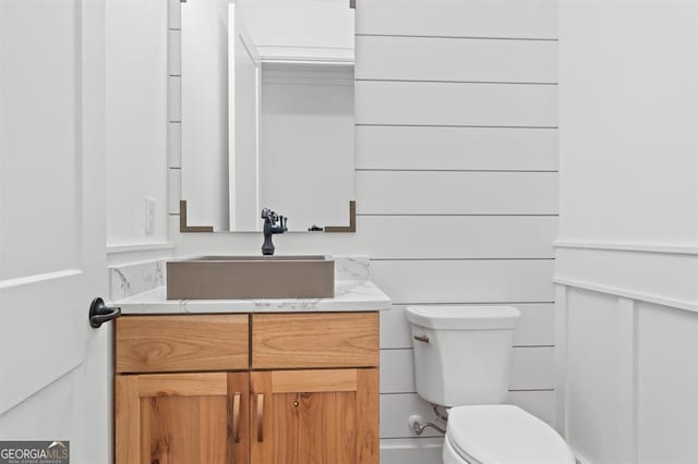 bathroom featuring toilet and vanity