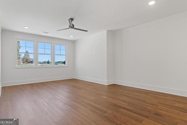 empty room featuring hardwood / wood-style flooring, ceiling fan, and crown molding