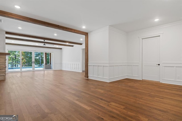 unfurnished room with a fireplace, beam ceiling, hardwood / wood-style floors, and crown molding