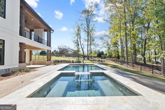 view of swimming pool featuring ceiling fan and an in ground hot tub