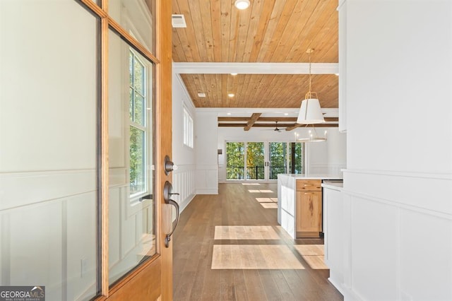 hallway with a wealth of natural light, beamed ceiling, hardwood / wood-style flooring, and wooden ceiling