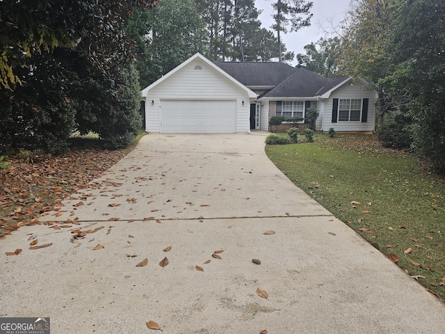 ranch-style home with a front yard, concrete driveway, and an attached garage