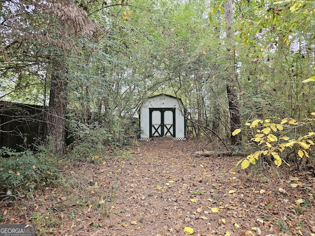 view of shed with a forest view