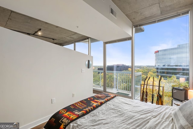 bedroom featuring wood-type flooring and floor to ceiling windows