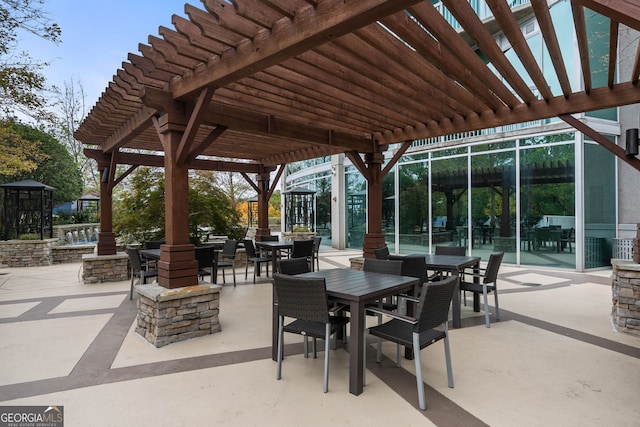 view of patio featuring a pergola and a fire pit