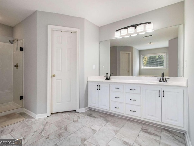 bathroom with walk in shower and vanity