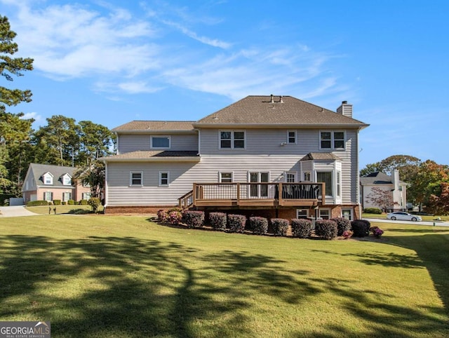 back of property with a yard and a deck