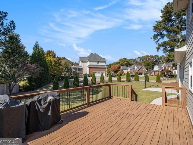 wooden terrace with a lawn