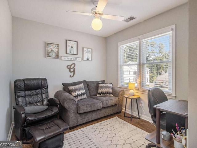 interior space with wood-type flooring and ceiling fan