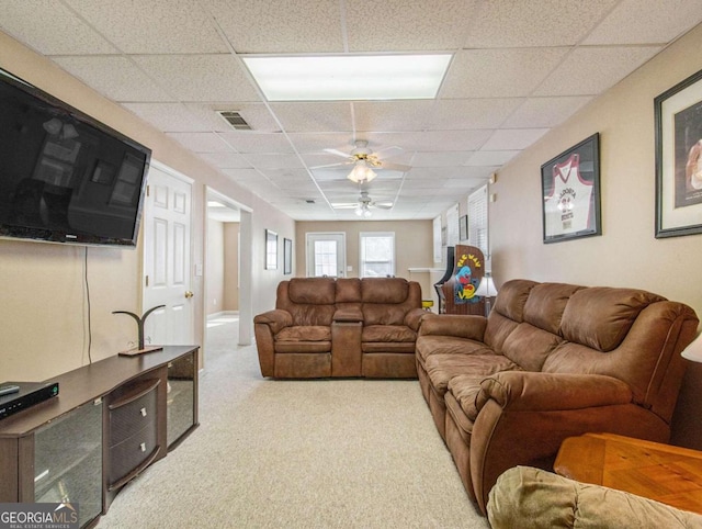 carpeted living room with a paneled ceiling and ceiling fan