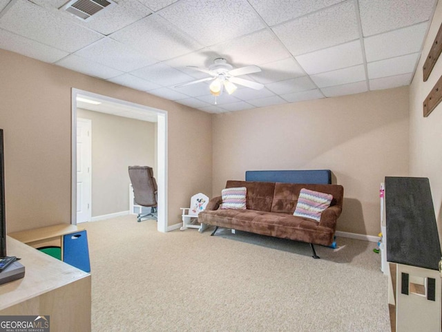 carpeted living room with a paneled ceiling and ceiling fan