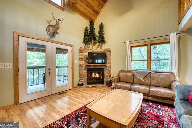 living room featuring french doors, plenty of natural light, hardwood / wood-style floors, and high vaulted ceiling