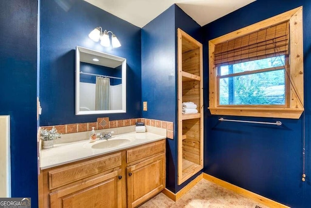 bathroom with a shower with shower curtain and vanity