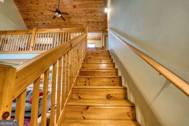 stairs featuring wooden ceiling, ceiling fan, wood-type flooring, and lofted ceiling