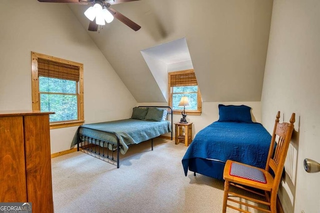 bedroom with lofted ceiling, multiple windows, ceiling fan, and light carpet