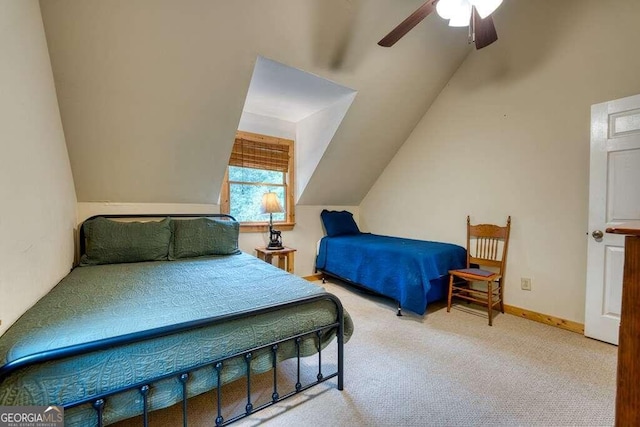 carpeted bedroom featuring ceiling fan and vaulted ceiling