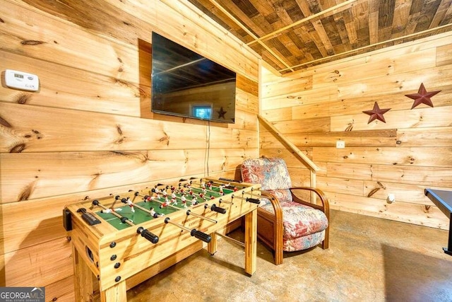 recreation room featuring wooden walls