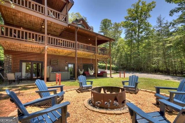 exterior space featuring a patio, a deck, and an outdoor fire pit