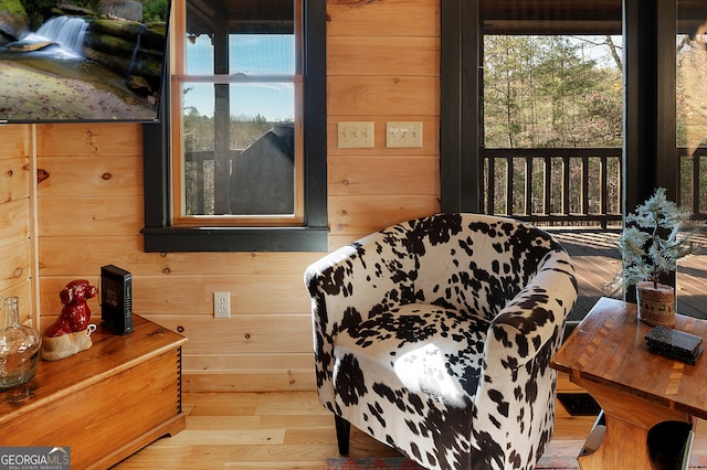 bedroom with wooden walls and hardwood / wood-style flooring