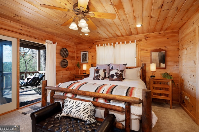 carpeted bedroom featuring access to exterior, ceiling fan, wooden ceiling, and wood walls