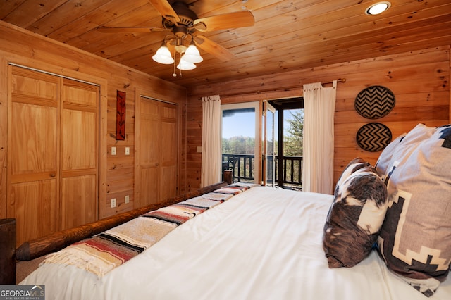 bedroom with ceiling fan, access to exterior, wood ceiling, and wooden walls