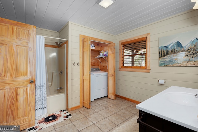 bathroom featuring tile patterned flooring, wood walls, washer / dryer, and shower / bathtub combination with curtain