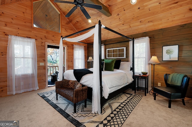 carpeted bedroom with access to exterior, ceiling fan, wooden walls, and wooden ceiling