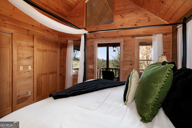 bedroom with wooden walls, wood ceiling, and lofted ceiling