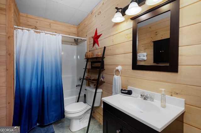 full bathroom with vanity, wooden walls, tile patterned flooring, toilet, and shower / tub combo with curtain