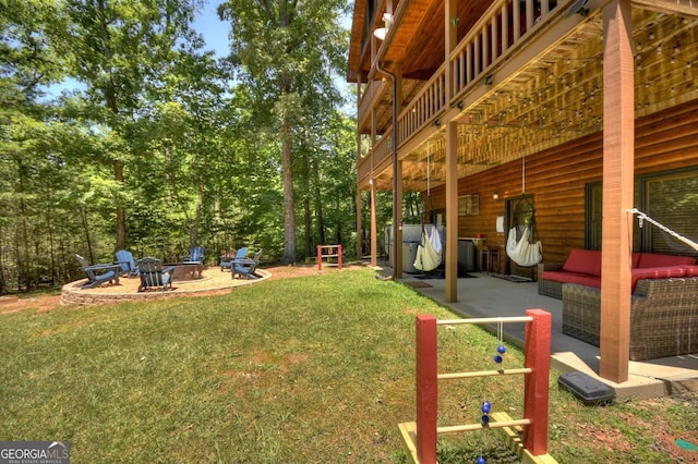 view of yard with a patio and an outdoor living space with a fire pit