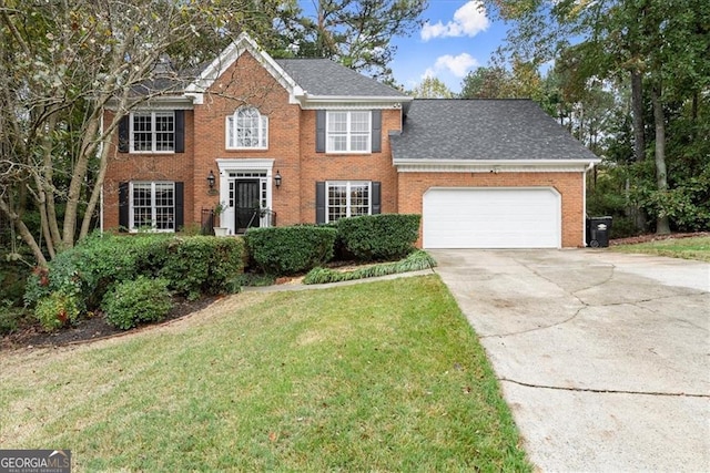 colonial-style house featuring a garage and a front lawn