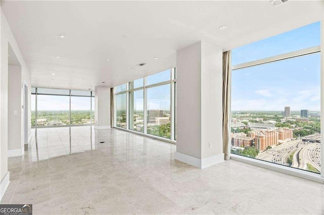 unfurnished room featuring floor to ceiling windows